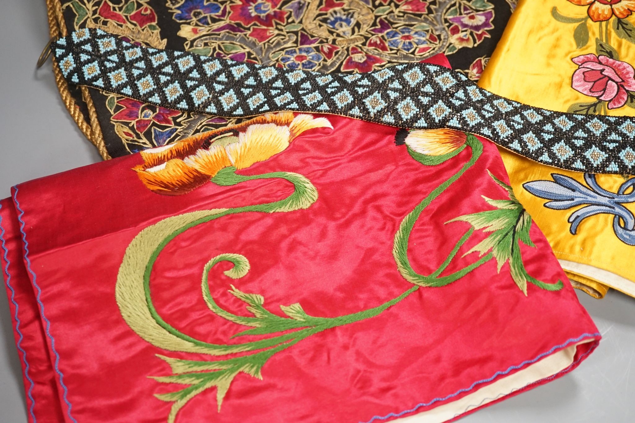 A Berlin beadwork panel , another, a beaded cushion, a book and embroidered banners, 2 silk panels etc